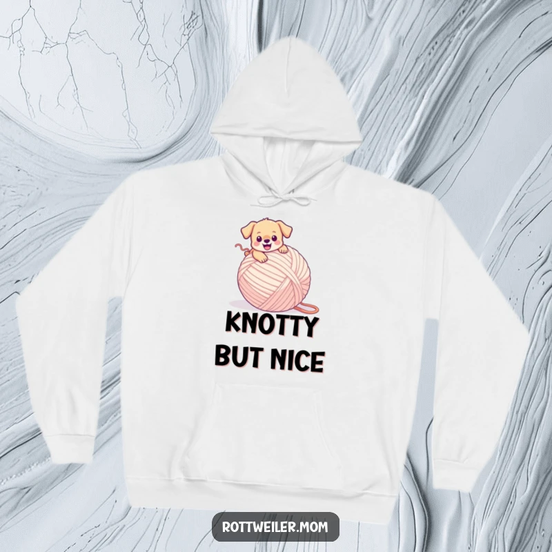 Funny puppy hoodie depicting a tiny dog happily stumbling over an enormous ball of yarn, looking utterly adorable.