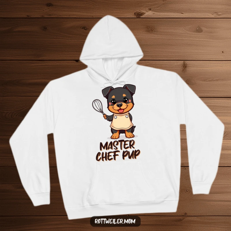 Funny hoodie featuring a kawaii Rottweiler in an apron, happily holding a whisk, perfect for a cozy baking session.