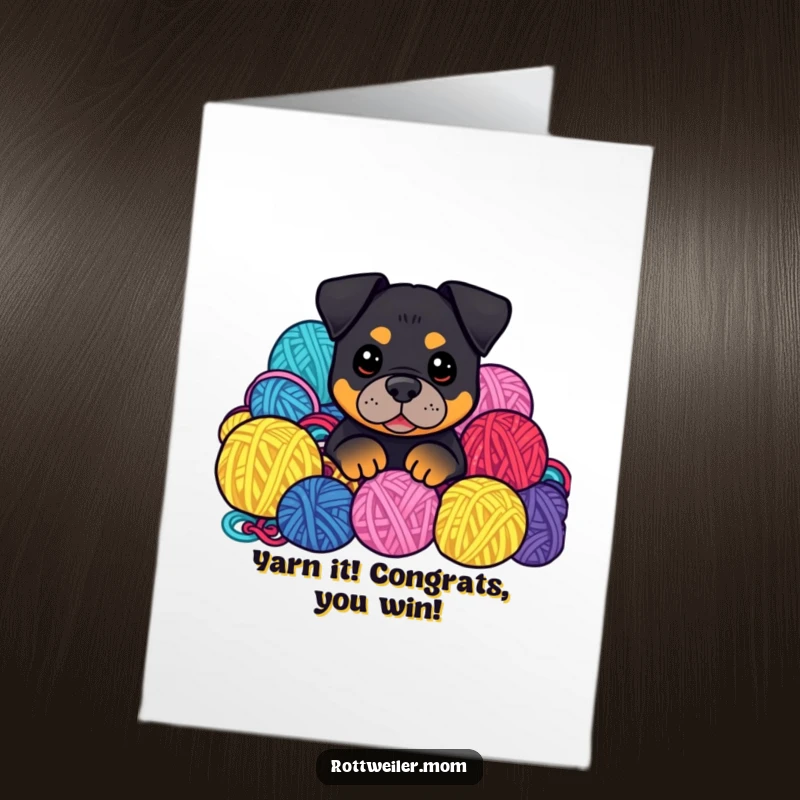 Funny Free Printable Congrats Card: Kawaii Rottweiler peeking from a pile of colorful yarn balls, celebrating achievements with a playful, tangled spirit.