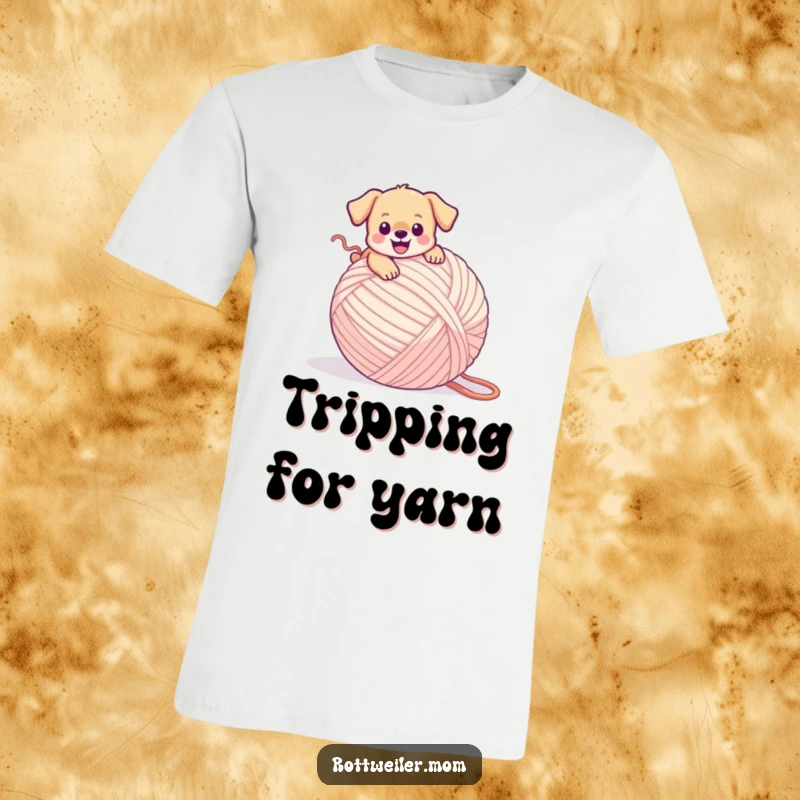 Funny puppy T-shirt with a tiny dog joyfully tripping over a massive ball of yarn, caught in a sweet, tangled mess.