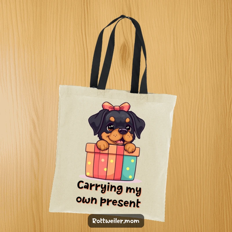 Funny Rottweiler Gift Box Tote Bag: A tote bag showing a rottweiler excited by a gift box, perfect for shoppers.