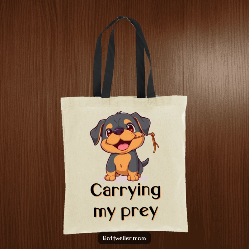 Funny Rottweiler tote bag featuring a playful pup with happy eyes, batting at a dangling string, perfect for everyday fun.